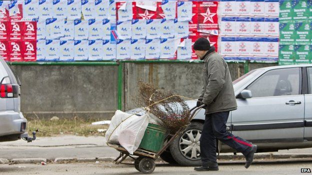 A man passes in front of electoral posters in Moldova's capital Chisinau. Photo: 26 November 2014