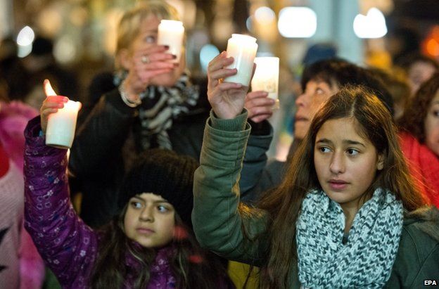 Women and girls hold candles outside Ms Albayrak's hospital in Offenbach, 28 November