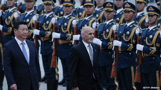 Chinese President Xi Jinping (L) accompanies Afghan President Ashraf Ghani (R) to view an honour guard during a welcoming ceremony outside the Great Hall of The People on 28 October 2014 in Beijing, China.