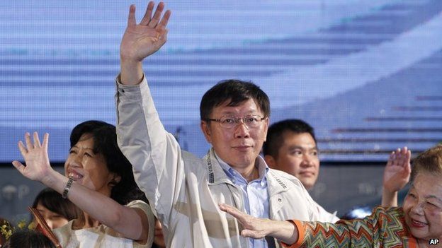 Taipei's new mayor Ko Wen-je waves to supporters at his campaign headquarters in Taipei in Taiwan,on 29 November 2014