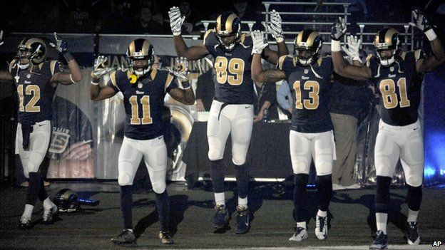 Members of the St Louis Rams raised their arms in St Louis, Missouri, on 30 November 2014