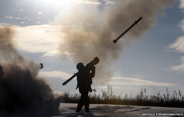 A Ukrainian soldiers fires a missile with a man-portable air-defense system during exercices near the city of Shchastya, north of Lugansk, on December 1, 2014