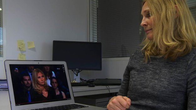 Karine Charbonnier-Beck looks at video of her performance on the TF1 programme Face aux Francais