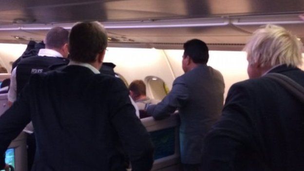 Boris Johnson and police onboard a plane