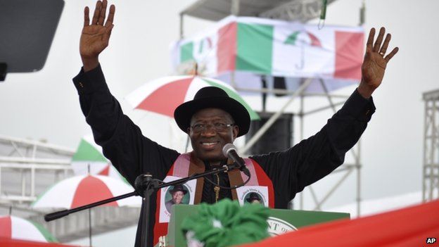 Nigeria's President Goodluck Jonathan waves to his supporters during a political rally declaring his intention to run in next year"s election in Abuja on 11 November 2014