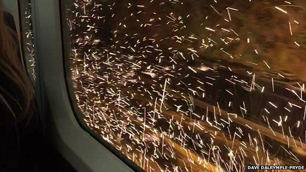 Sparks are seen from inside the train