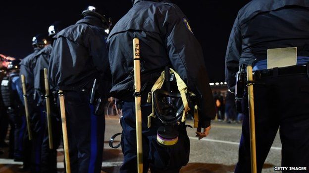 Police in riot gear line up against protesters in Ferguson, Missouri, on November 25, 2014