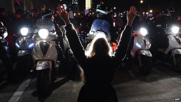 A protestor hold up her hands in front of police in New York on 4 December 2014