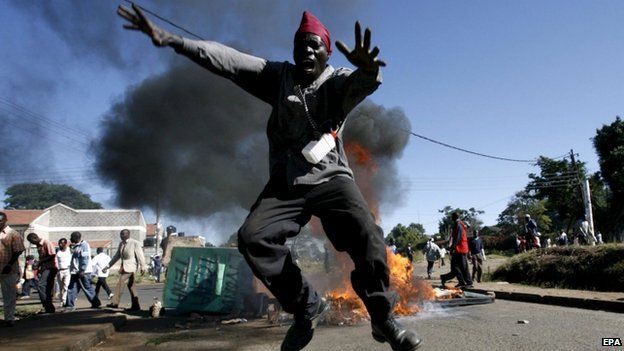 An opposition supporter jumps over a fire during a post-election violence in Nairobi, Kenya. Photo: 2008