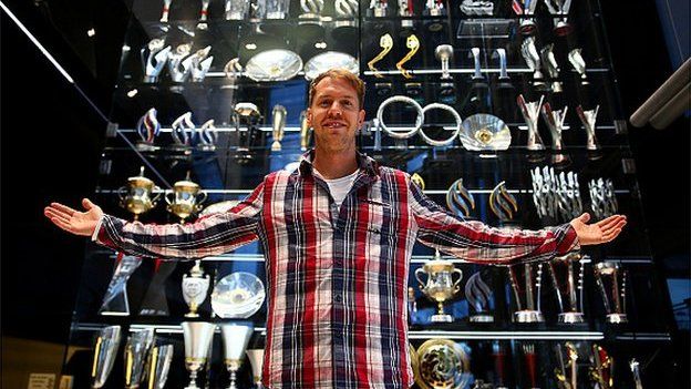 Sebastian Vettel with the trophy cabinet at Red Bull