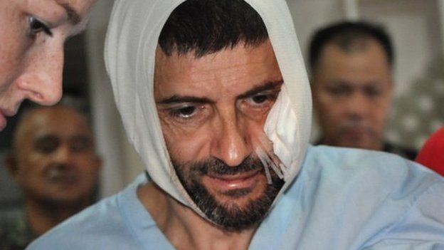 Swiss hostage Lorenzo Vinciguerra, is treated in a hospital following his daring escape from the hands of the Muslim Abu Sayyaf extremists, in Jolo in southern Philippines, Saturday, Dec. 6, 2014