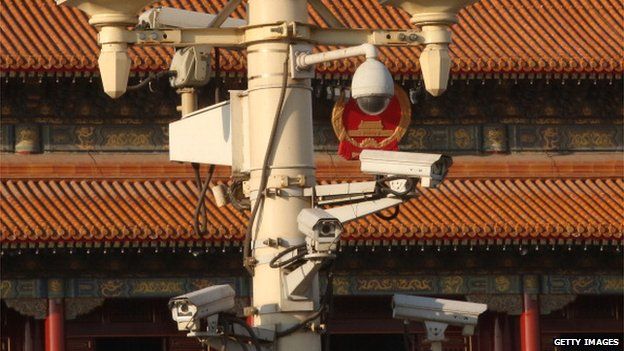Security cameras hang on a lamp at the Tiananmen Square ahead on 1 March, 2014 in Beijing, China