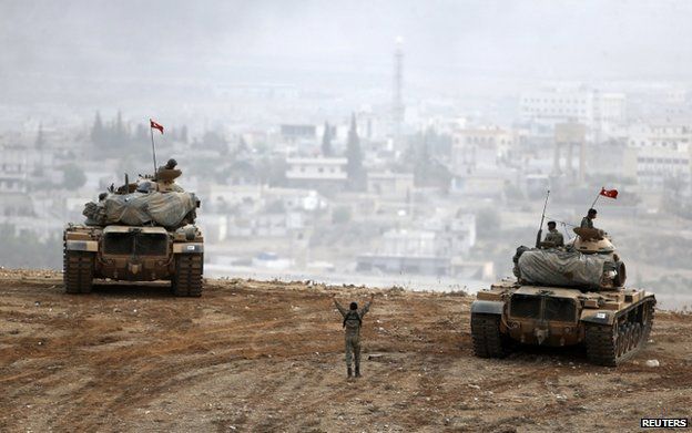 Turkish tanks face Kobani across the border with Syria, 11 October