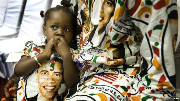 Two-year-old Princess Smith sits with her father Francis Smith on 11 July 2009 as they wait for US President Barack Obama's arrival at the International Conference Centre in Accra, Ghana