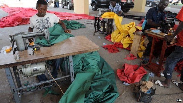 Tailors work on national colours on 6 January 2013 ahead of presidential inauguration in Accra