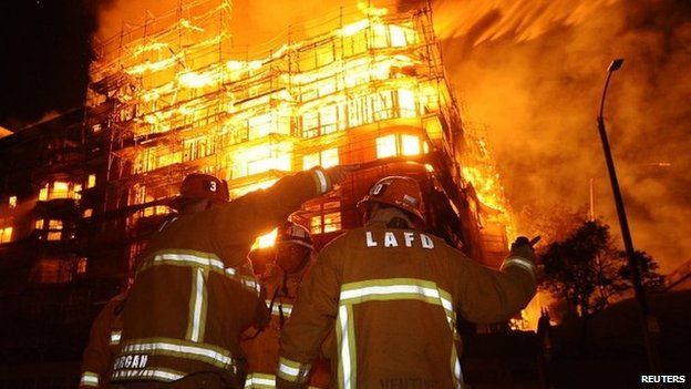 Los Angeles city firefighters battle a massive fire at a seven-storey downtown apartment complex under construction in Los Angeles, California 8 December 2014