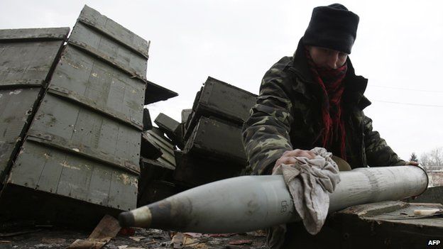 A Ukrainian artilleryman prepares shells at their position near the eastern Ukrainian village Pisky, Donetsk region to be fired at the position of pro-Russian separatists at Donetsk airport on December 8, 2014