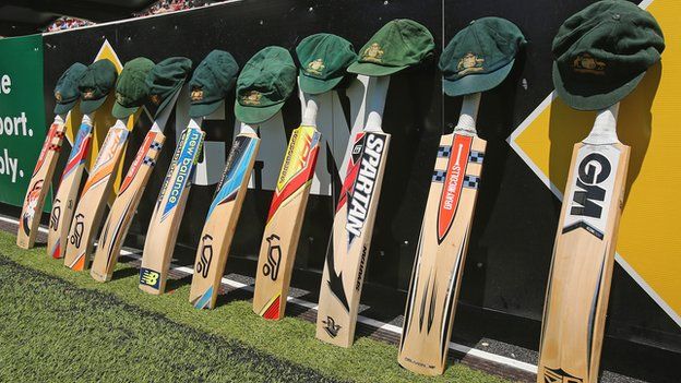 Bats and caps are left out in memory of the late Phillip Hughes