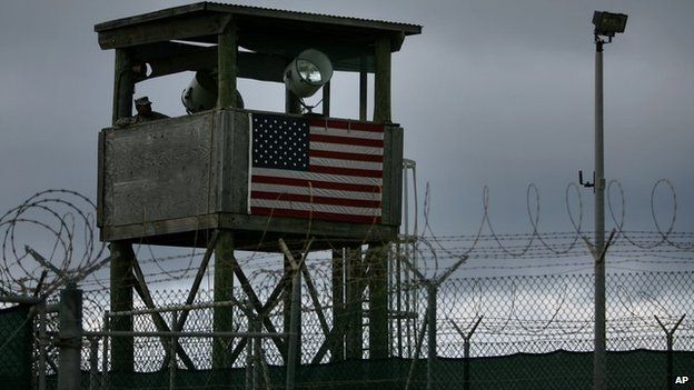 A guards sits in a tower overlooking Guantanamo detention camp at Guantanamo Bay US Naval Base, Cuba, Tuesday, May 15, 2007