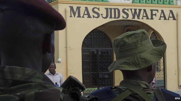 Kenyan police stand guard outside a mosque in Mombasa