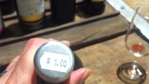 A 750ml bottle of red wine for sale for A$1.00 in a 'throw out bin' at a Wines Direct outlet in Melbourne, Australia