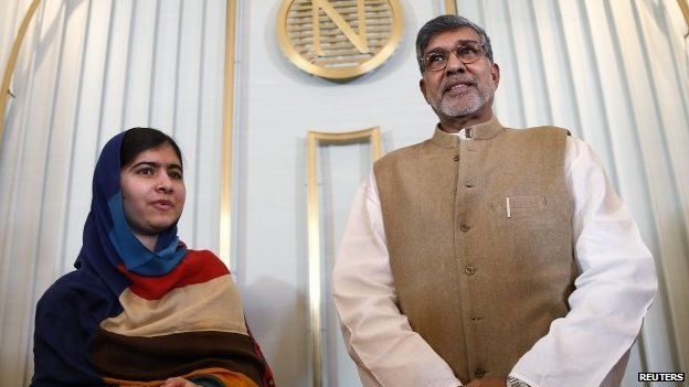 Nobel Peace Prize laureates Kailash Satyarthi (right) and Malala Yousafzai pose for photographers after a news conference in Oslo (9 December 2014)