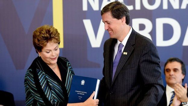 Brazilian President Dilma Rousseff receives the final report, 10 December, 2014.