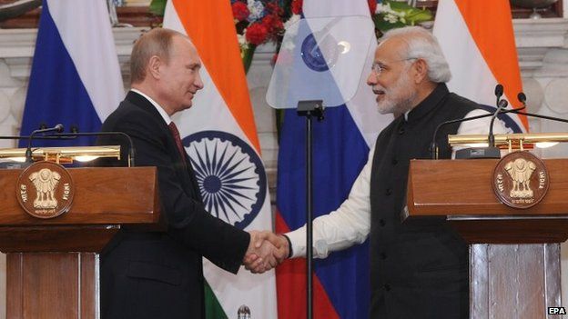 Indian Prime Minister Narendra Modi (R) shakes hands with Russian President Vladimir Putin (L) during a joint media briefing in New Delhi, India on 11 December 2014