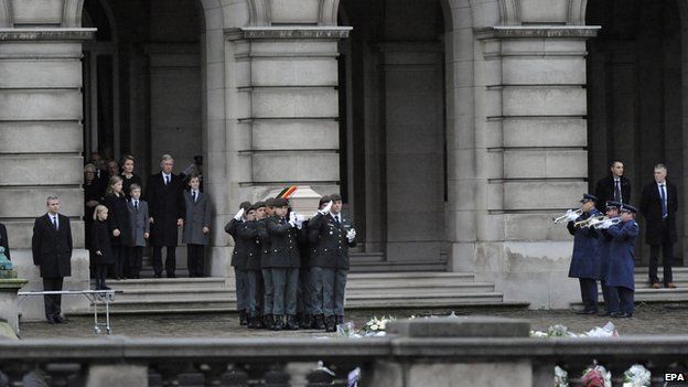 Pallbearers carry the coffin of Queen Fabiola outside the Brussels Palace