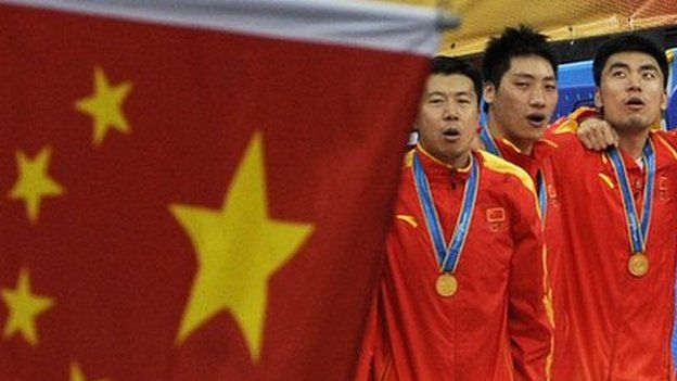 Gold medallists from China sing the national anthem during the award ceremony for the men's basketball gold medal match at the 16th Asian Games in Guangzhou on November, 2010.