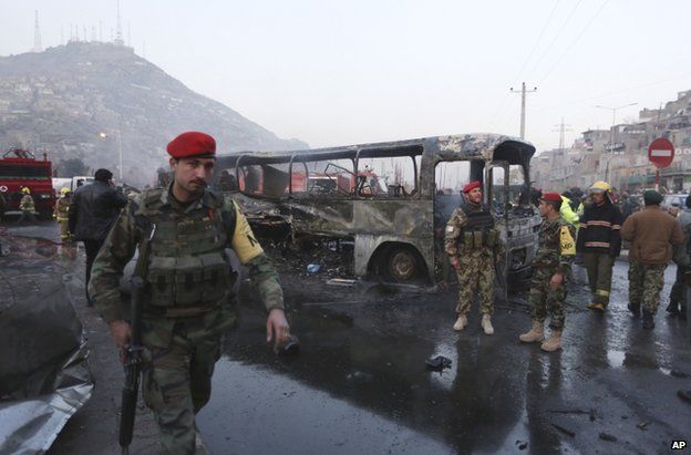 Soldiers secure the scene of the bus attack in Kabul, 13 December
