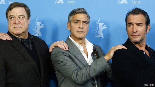 George Clooney with his Monuments Men co-stars John Goodman (l) and Jean Dujardin (r)