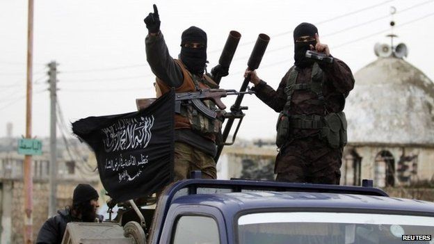 Al-Nusra Front fighters drive through the Idlib countryside on 2 December 2014