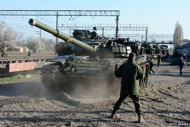 Russian soldiers unload trainload of their modified T-72 tanks after their arrival in Gvardeyskoe railway station near the Crimean capital Simferopol, on March 31, 2014.