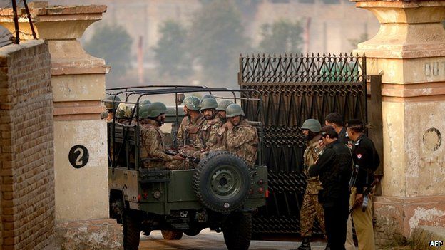 Soldiers stand guard at school gate in Peshawar. 17 Dec 2014