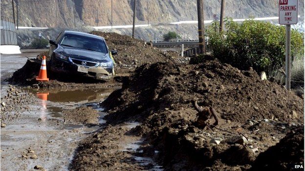 A car is trapped in a mud slide that closed a 10-mile portion of the Pacific Coast Highway, near Point Mugu, California