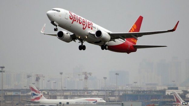 An Indian-operated SpiceJet Boeing 737-800 aircraft (foreground) takes off in Mumbai