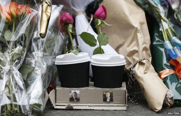 Coffee cups with one rose placed in each, with images of the two victims who died in the cafe siege, lawyer Katrina Dawson (L) and Lindt store manager Tori Johnson, at a makeshift memorial in Sydney, 17 December 2014.