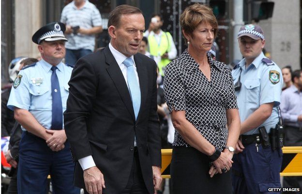 Prime Minister Tony Abbott and his wife Margie visit the Martin Place memorial site on 16 December 2014 in Sydney, Australia