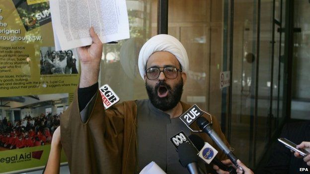A picture made available 15 December 2014 shows Muslim cleric Man Haron Monis speaking to the media after leaving court after he had been charged with seven counts of unlawfully using the postal service to menace in Sydney on 10 November 2009