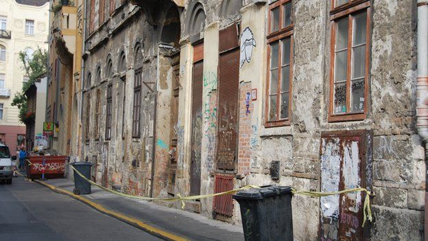 Street in Budapest with cordon to warn people of falling plaster