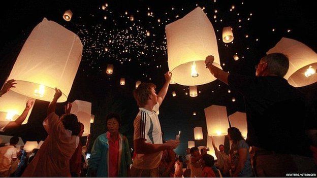 Mourners launch thousands of floating paper lanterns into the sky over the Andaman Sea in remembrance of the 2004 Indian Ocean tsunami victims, in Khao Lak, in Thailand