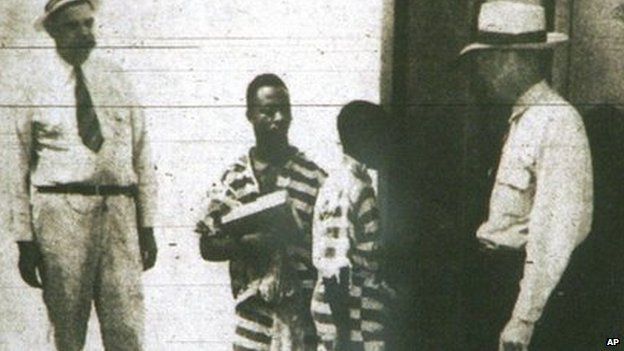 In this June 8, 1944 copy of a photo from The Columbia Record, George Stinney, Jr., 14, center right, and Bruce Hamilton, 21, center left, both of Chicora, Georgia as they enter the death house in the state prison in Columbia, South Carolina. Both were executed in the state's electric chair 16 June 1944