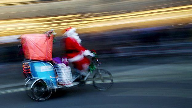 Father Christmas doing the rounds by bike