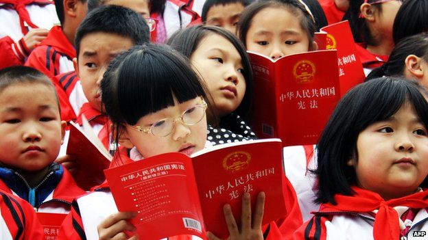 This picture taken on 2 December, 2014 shows young students reading the Constitution of the People's Republic of China in Yunyang county, southwest China's Chongqing municipality