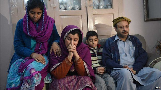 Andaleeb Aftab, a teacher at the school, mourns her child with her husband, son and daughter