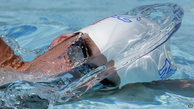 Michael Phelps warms up prior to a 50m freestyle preliminary heat at the Arena Grand Prix swim event, Friday, April 25, 2014, in Mesa, Arizona