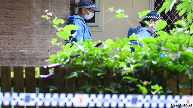 Forensic teams at the Cairns home where eight children were killed