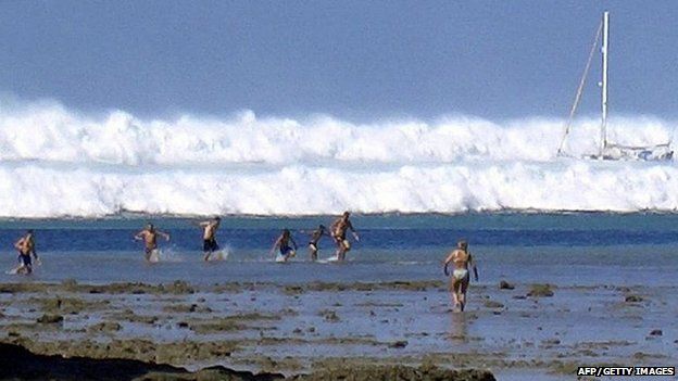 File photo dated 26 December 2004 shows tourists caught by the first of six tsunami rolling towards Hat Rai Lay Beach, near Krabi in southern Thailand