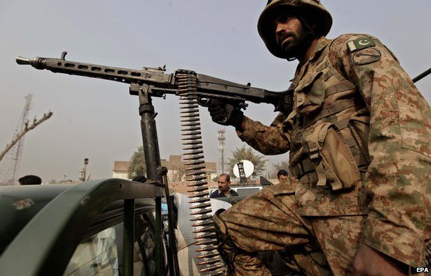 A Pakistani army soldier stands guard outside the Army Public School in Peshawar, Pakistan, 19 December 2014